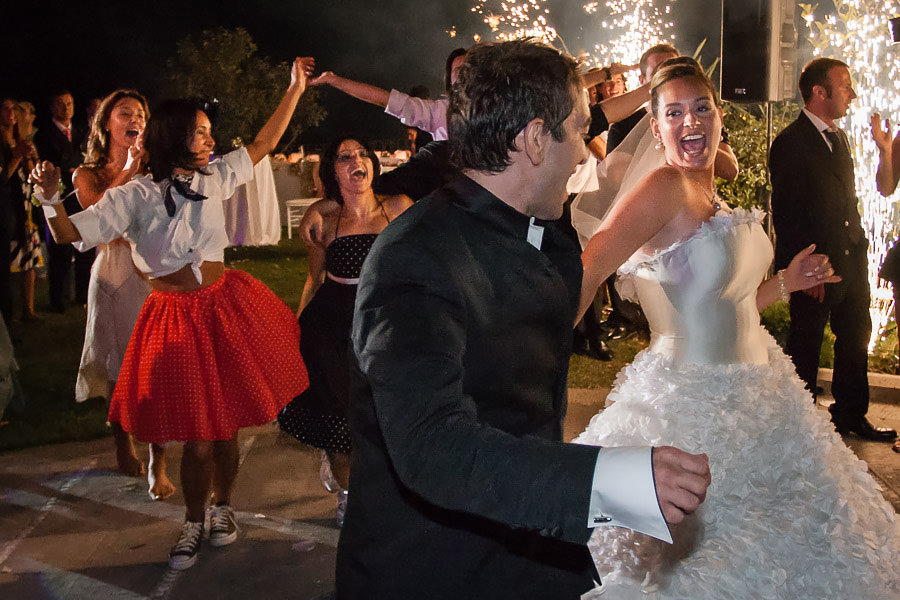 bride and groom perform Grease show with friends at wedding