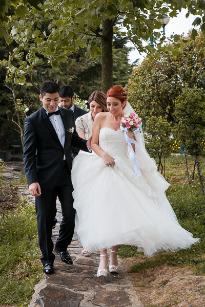 bridal party trying to keep their feet dry on a rainy day