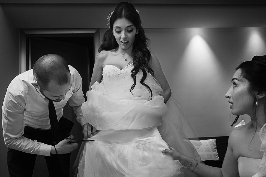 Crazy wedding: bride getting her wedding dress cut