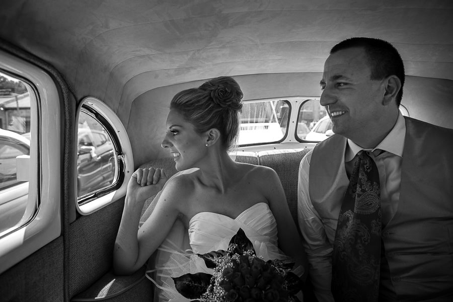 bride and groom in classic automobile