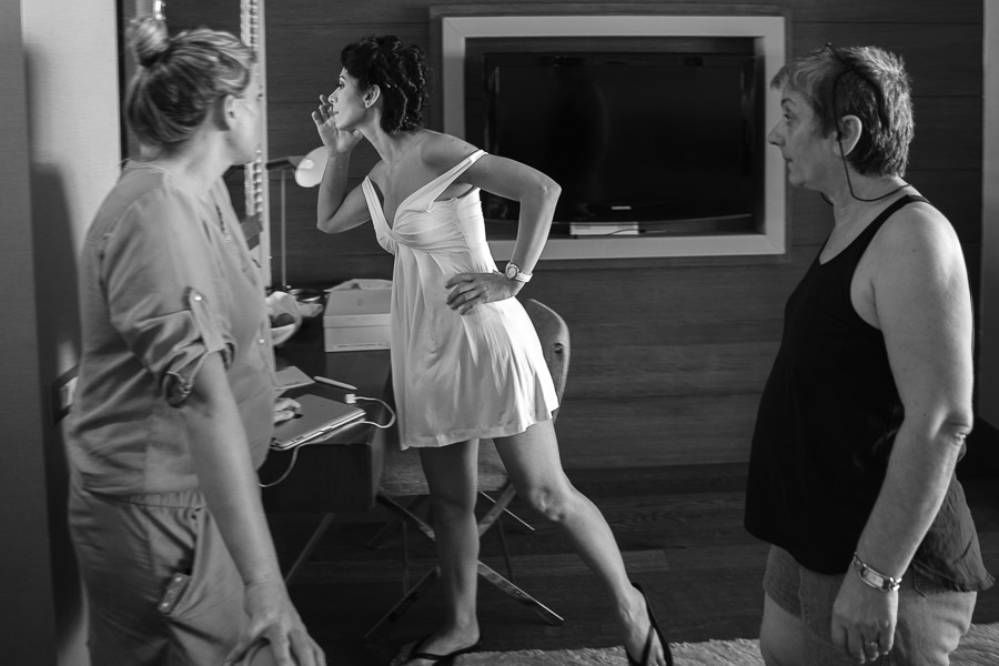 Bride-to-be checking her make-up as mom and friend watches