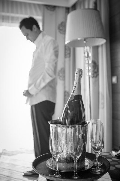 Groom getting ready and a bottle of champagne