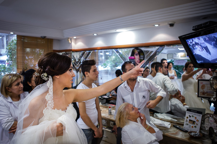 bride pointing at the security footage of the theft that occured at hair dresser's