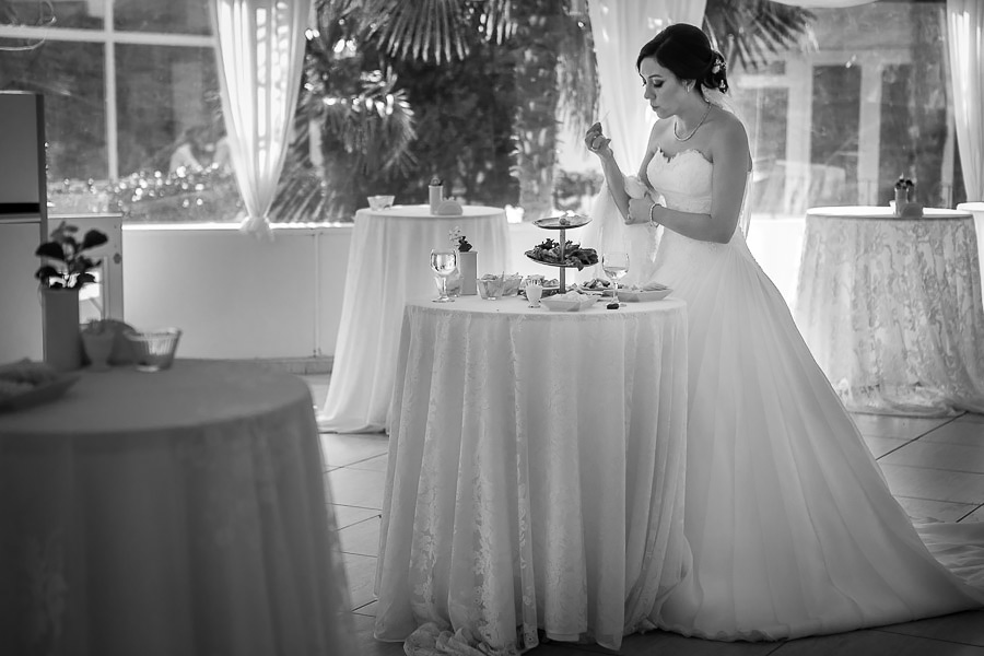 hungry bride feeding on the leftovers from the coctail 