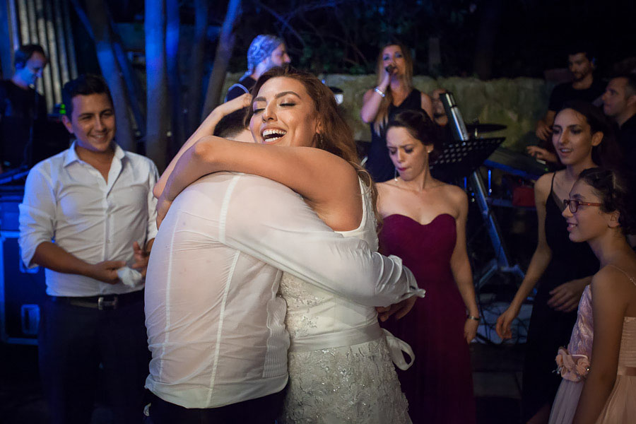 bride hugs sweaty groom in diy backyard wedding 