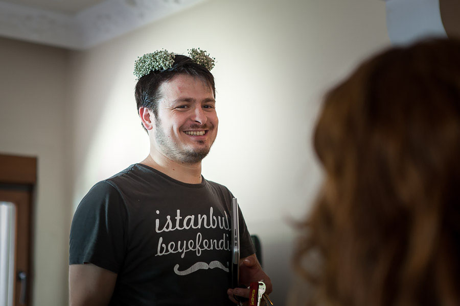 groom wearing bride's headpiece