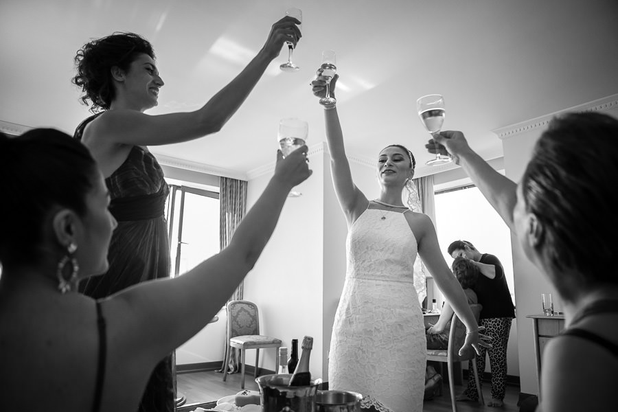 bride and friends raise a glass before wedding