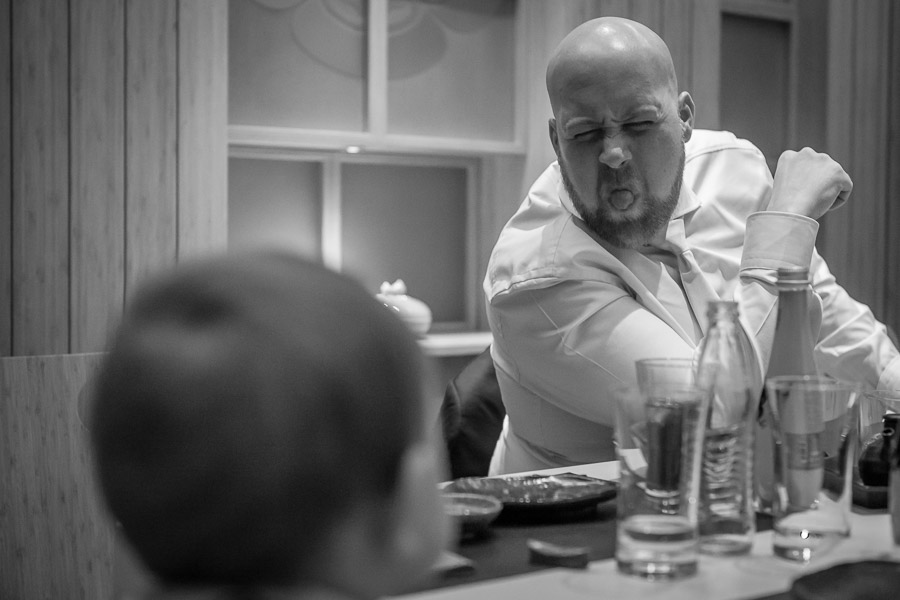 groom making funny faces at the child