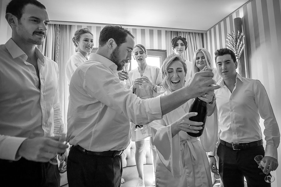 Bride opening a champagne
