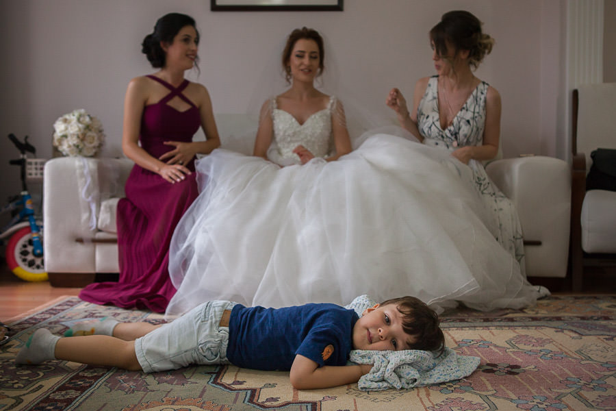boy lying in front of the bride