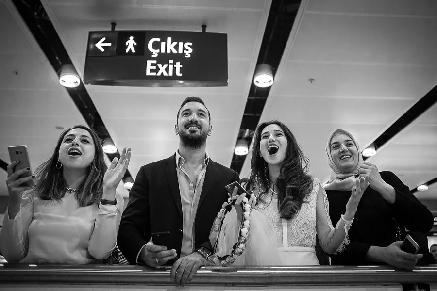 bride and groom waiting for singer at airport