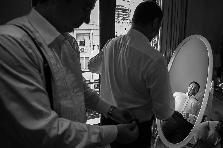 groom checking himself in the mirror