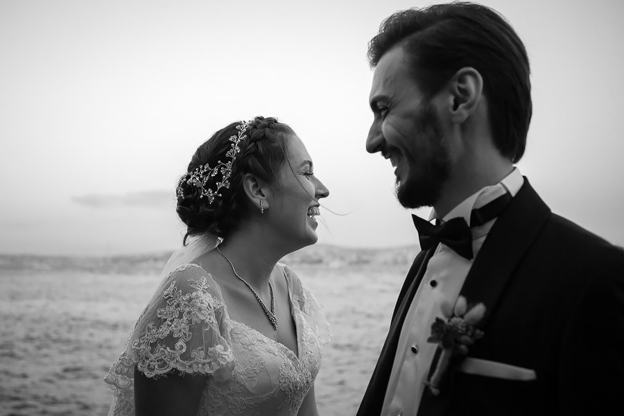 bride and groom pose by the sea wedding at sardunya