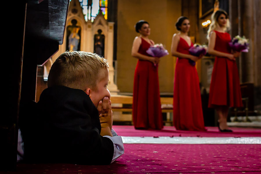 ring bearer watching the bridesmaids at istanbul st. anthony of padua wedding