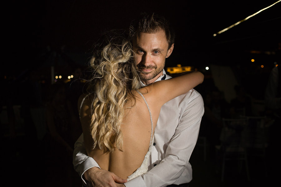 bride hugs groom at wedding reception