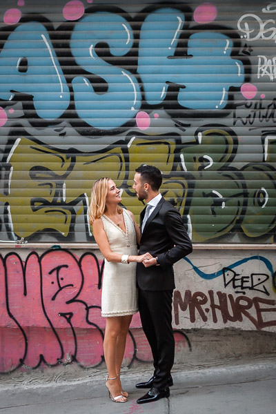 bride and groom in front of graffiti