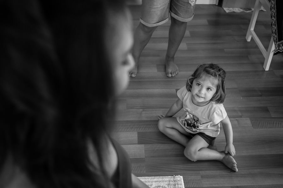 little girl watching bride getting ready