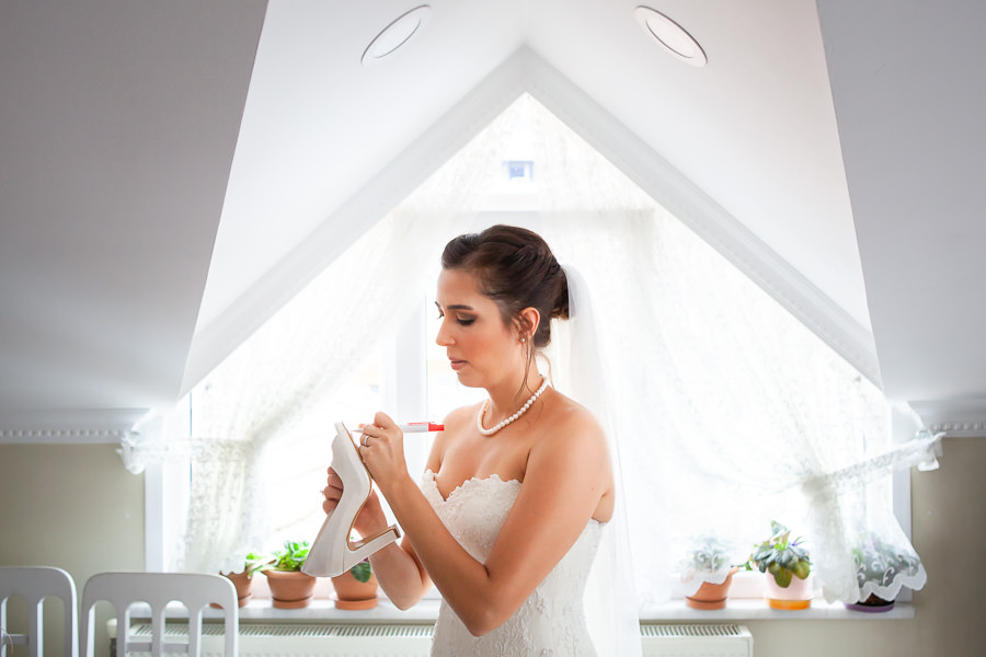 bride writing names on shoe sole