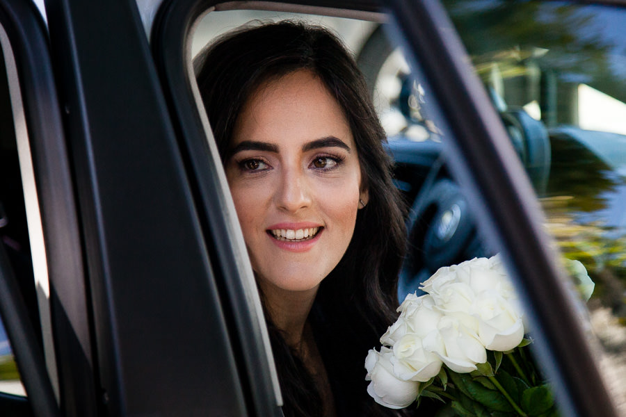 Bride looking out the car door