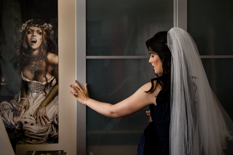 Bride shutting the dresser's door with fantasy bride poster on the wall