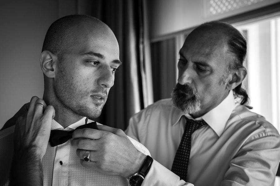 dad helps groom getting ready